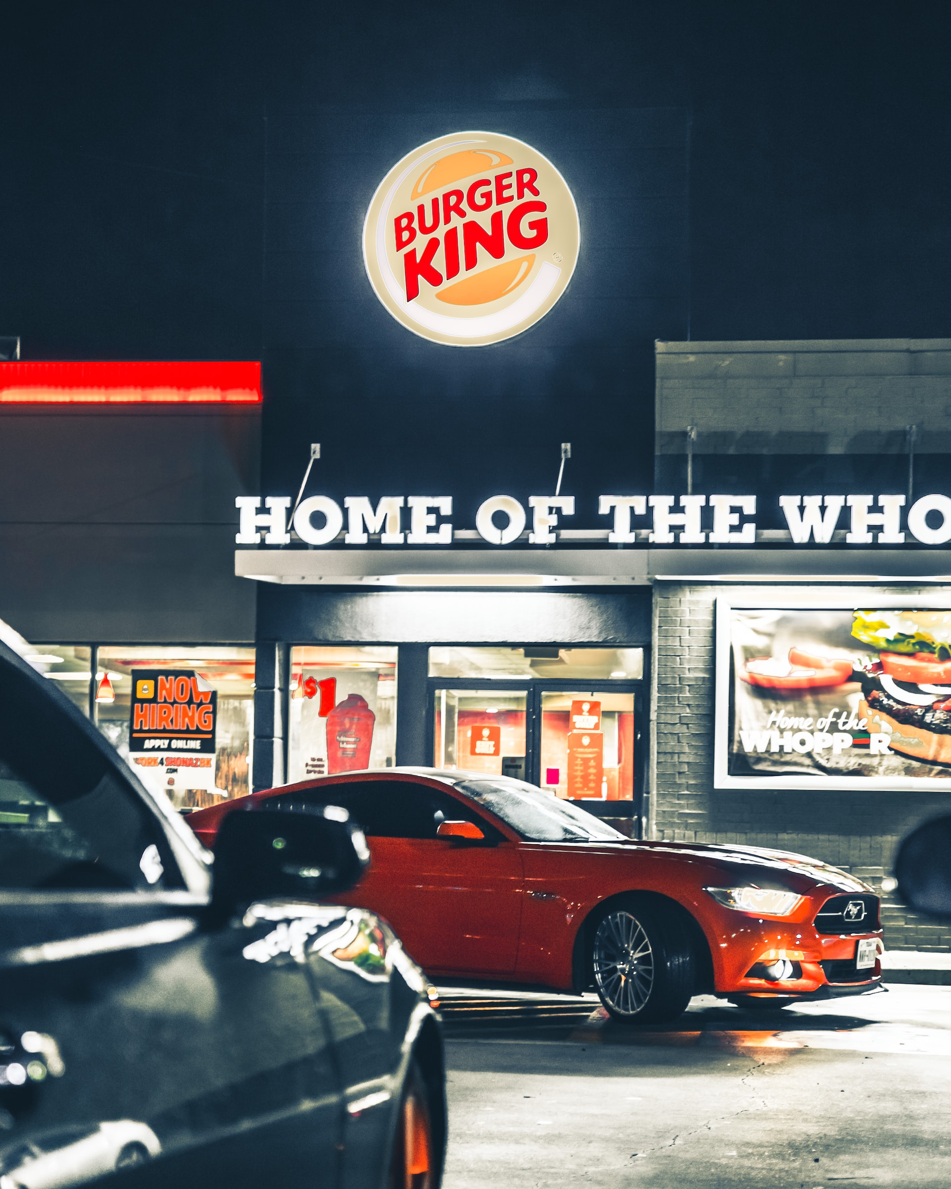 Dodge car in front of a burger king shop