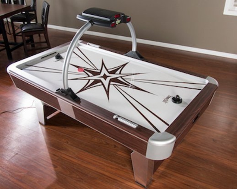 American Heritage Monarch Air Hockey Table on a wooden floor
